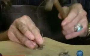 Jeweler hammering silver ring