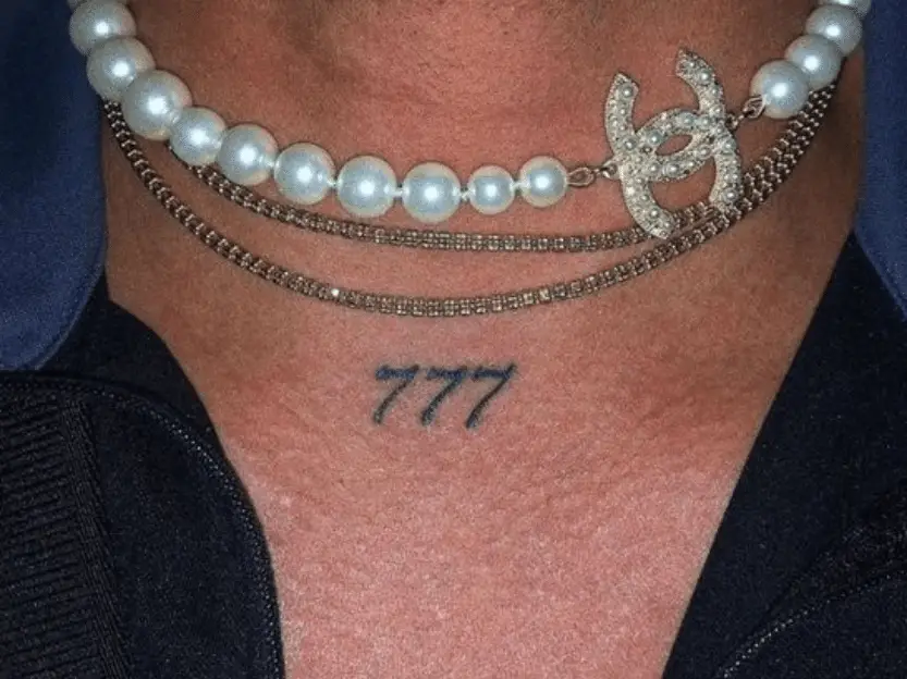 777 tattoo on the front neck