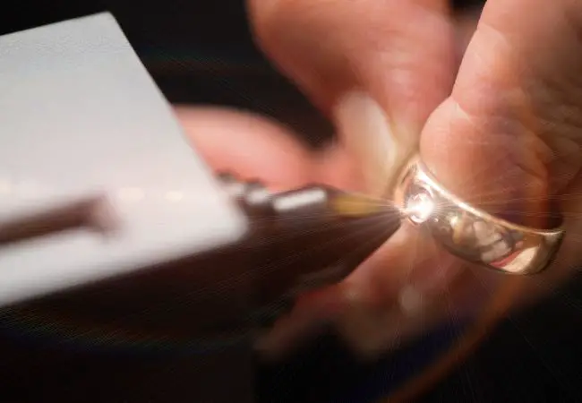 Jewelers using diamond tester for diamond testing